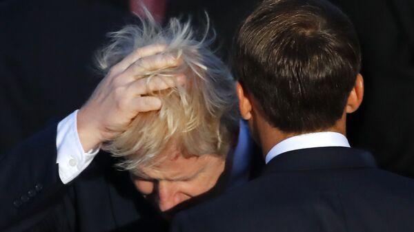 Britain's Prime Minister Boris Johnson touches his hair beside French President Emmanuel Macron during the G7 family photo on Sunday, 25 August 2019 in Biarritz. - Sputnik International
