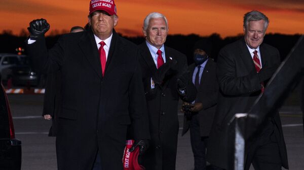 President Donald Trump and Vice President Mike Pence arrive for a campaign rally at Cherry Capital Airport, Monday, Nov. 2, 2020, in Traverse City, Mich., with White House chief of staff Mark Meadows, right. Meadows has been diagnosed with the coronavirus as the nation sets daily records for confirmed cases for the pandemic - Sputnik International