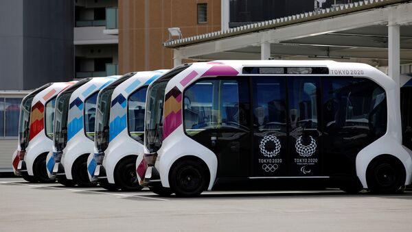 Electric vehicles are pictured at an internal shuttle bus station of the Tokyo 2020 Olympic and Paralympic Village in Tokyo, 20 June 2021 - Sputnik International