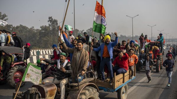 FILE - In this Jan. 26, 2021 file photo, protesting farmers ride tractors and shout slogans as they march to the capital breaking police barricades during India's Republic Day celebrations in New Delhi, India - Sputnik International