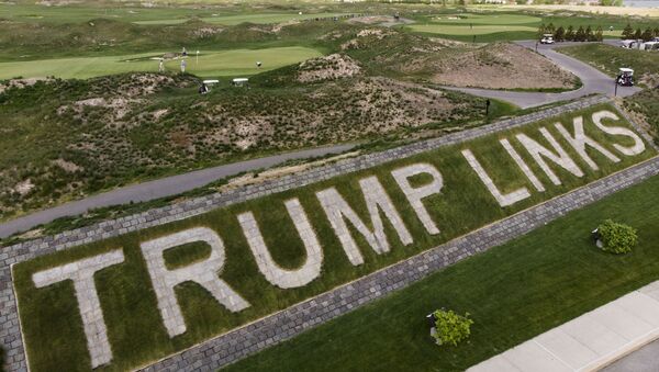 FILE - Patrons play the links as a giant branding sign is displayed with flagstones at Trump Golf Links at Ferry Point in the Bronx borough of New York on Tuesday, May 4, 2021. The Trump Organization sued New York City on Monday, June 21, 2021 for cancelling its contract to run a golf course in the Bronx earlier this year, a move it called ''politically motivated with no basis in the law that should be reversed. - Sputnik International
