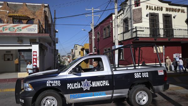 In this Feb. 10, 2020 file photo, a policeman drives past town hall in Apaseo El Alto, Guanajuato state, Mexico. The notoriously violent Jalisco cartel has responded to Mexico's “hugs, not bullets” policy with a policy of their own: the cartel kidnapped in mid-May 2021, several members of an elite police force in the state of Guanajuato, tortured them to obtain names and addresses of fellow officers, and are now hunting down and killing police at their homes, on their days off, in front of their families. - Sputnik International