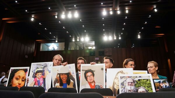 Family members hold photographs of Boeing 737 MAX crash victims lost in two deadly 737 MAX crashes that killed 346 people as Boeing CEO Dennis Muilenburg testifies before a Senate Commerce, Science and Transportation Committee hearing on “aviation safety” and the grounded 737 MAX on Capitol Hill in Washington, U.S., October 29, 2019 - Sputnik International