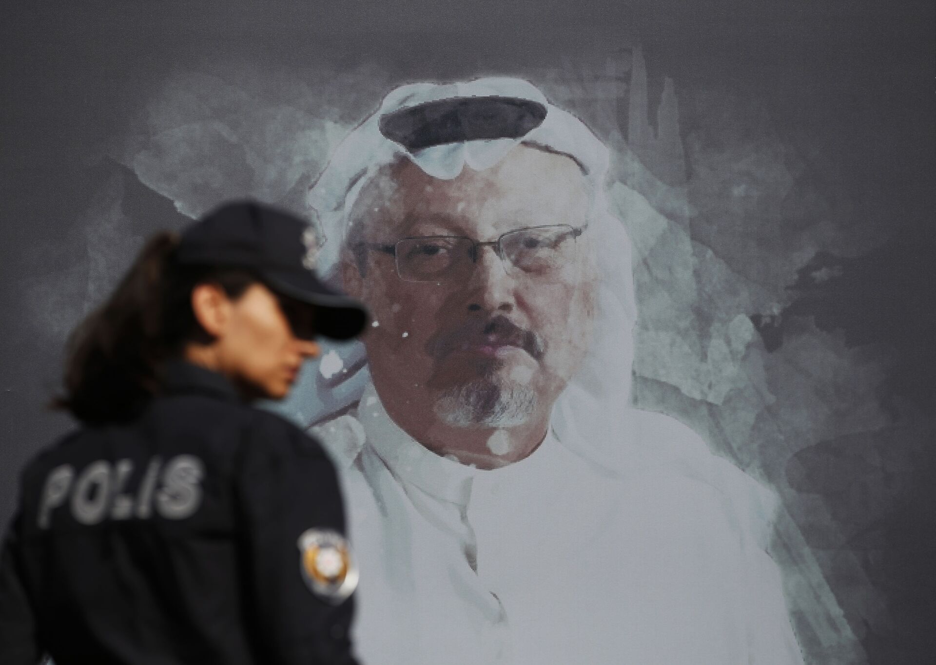 In this Wednesday, Oct. 2, 2019 file photo, a Turkish police officer walks past a picture of slain Saudi journalist Jamal Khashoggi prior to a ceremony, near the Saudi Arabia consulate in Istanbul, marking the one-year anniversary of his death. - Sputnik International, 1920, 07.09.2021