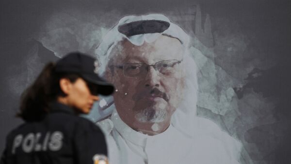 In this Wednesday, Oct. 2, 2019 file photo, a Turkish police officer walks past a picture of slain Saudi journalist Jamal Khashoggi prior to a ceremony, near the Saudi Arabia consulate in Istanbul, marking the one-year anniversary of his death. - Sputnik International