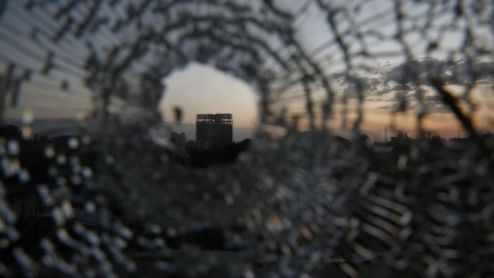 A building is seen through a bullet hole in a window of the Africa Hotel in the town of Shire, Tigray region, Ethiopia, March 16, 2021. Picture taken March 16, 2021 - Sputnik International, 1920, 29.06.2021