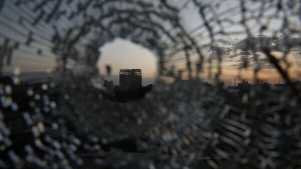 A building is seen through a bullet hole in a window of the Africa Hotel in the town of Shire, Tigray region, Ethiopia, March 16, 2021. Picture taken March 16, 2021 - Sputnik International