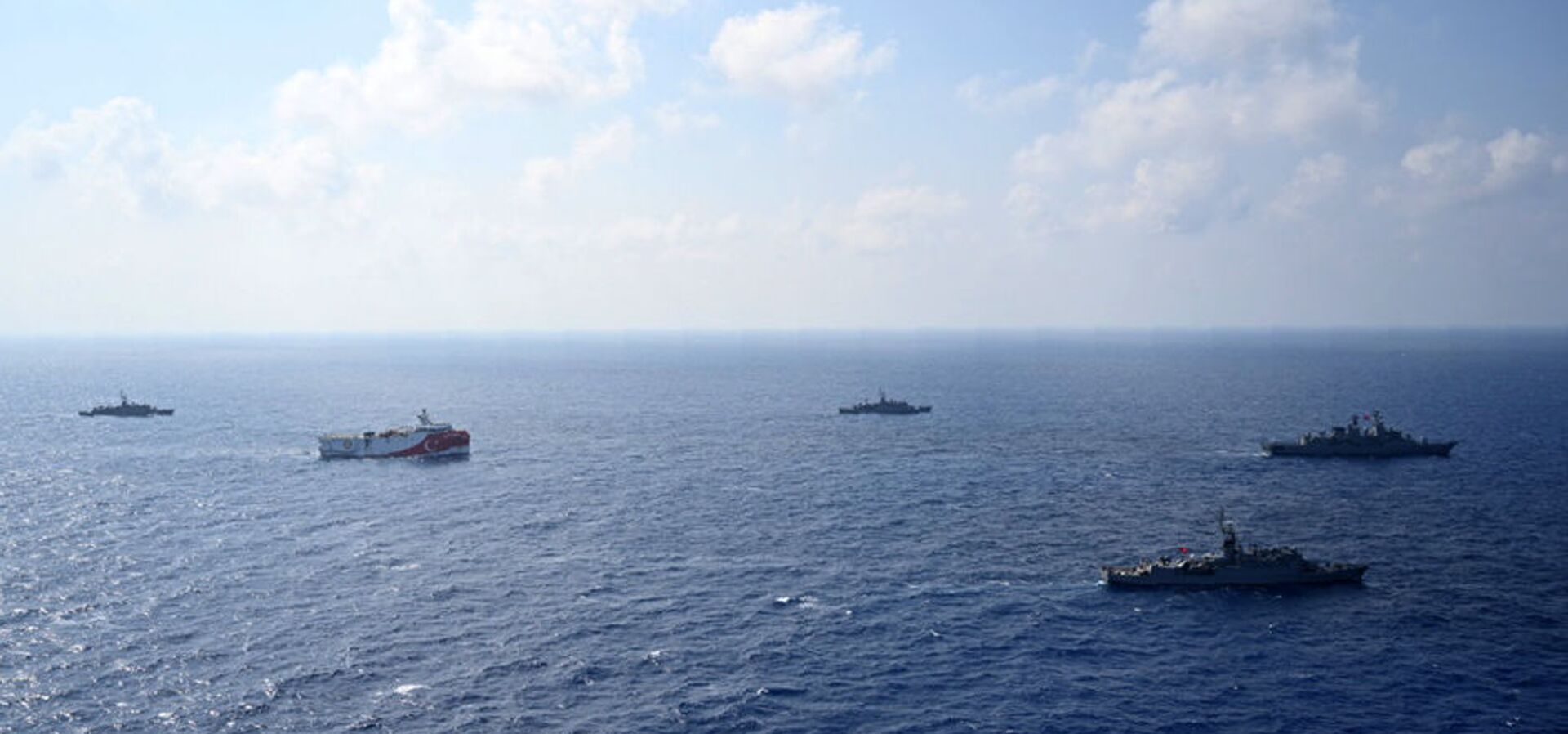 In this photo provided by the Turkish Defense Ministry, Turkey's research vessel, Oruc Reis, in red and white, is surrounded by Turkish navy vessels as it was heading in the west of Antalya on the Mediterranean, Turkey, Monday, Aug 10, 2020. - Sputnik International, 1920, 23.06.2021
