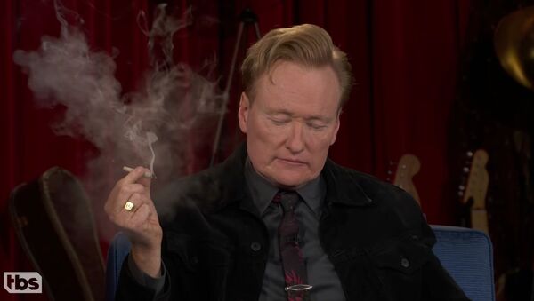Screenshot captures the moment in which late-night host Conan O'Brien smokes a marijuana joint with sidekick Andy Richter and guest Seth Rogen. - Sputnik International