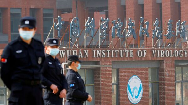 Security personnel keep watch outside the Wuhan Institute of Virology during the visit by the World Health Organization (WHO) team tasked with investigating the origins of the coronavirus disease (COVID-19), in Wuhan, Hubei province, China February 3, 2021.  - Sputnik International