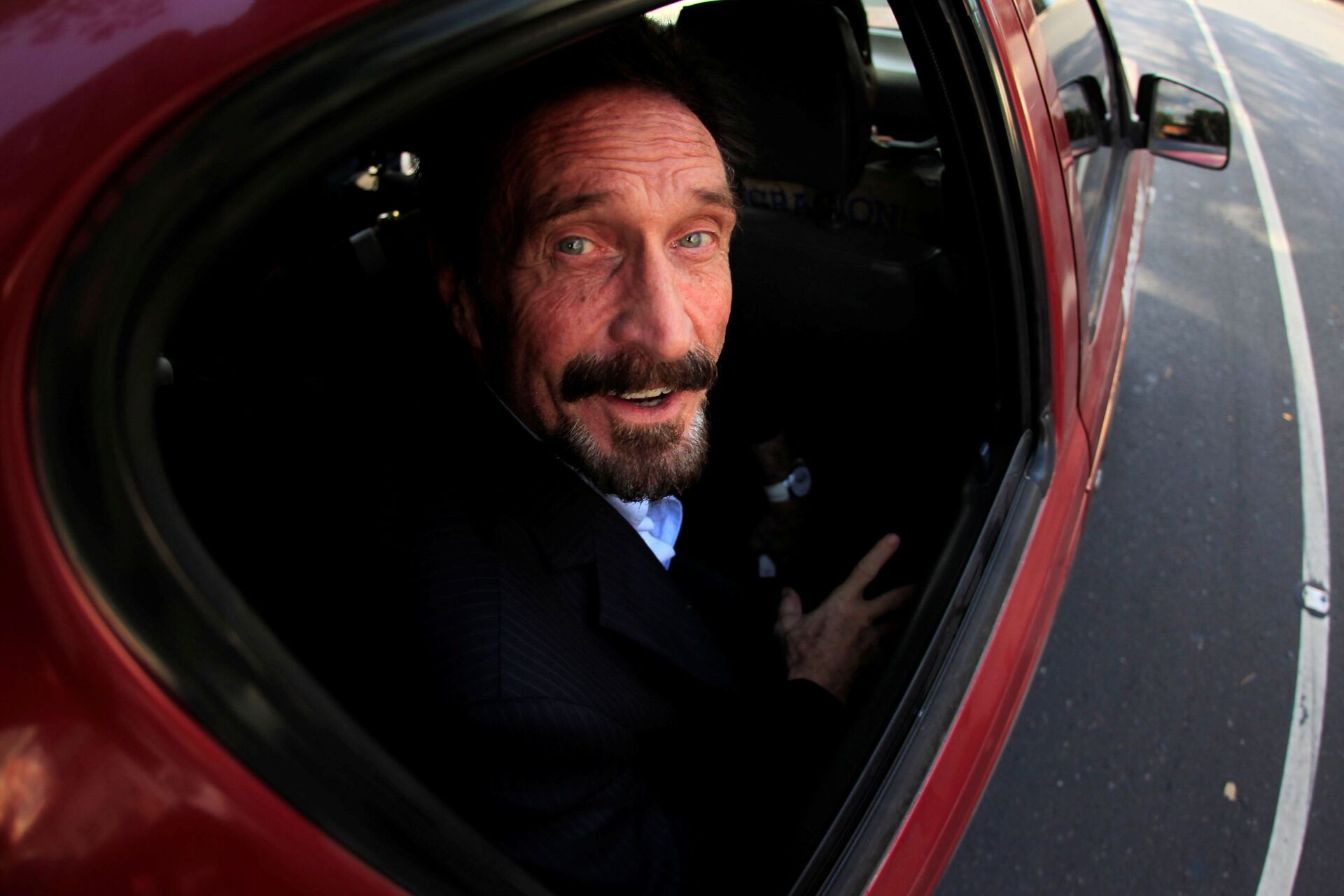 Software pioneer John McAfee is escorted by immigration officers to the Guatemalan Airport in Guatemala City December 12, 2012.  - Sputnik International, 1920, 08.01.2022