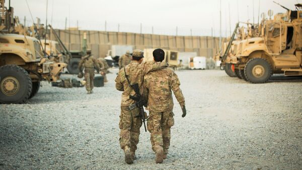 FILE PHOTO: A U.S. soldier from the 3rd Cavalry Regiment walks with the unit's Afghan interpreter before a mission near forward operating base Gamberi in the Laghman province of Afghanistan December 11, 2014. - Sputnik International