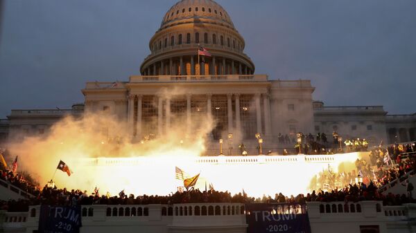 An explosion caused by a police munition is seen while supporters of U.S. President Donald Trump gather in front of the U.S. Capitol Building in Washington, U.S., January 6, 2021. - Sputnik International