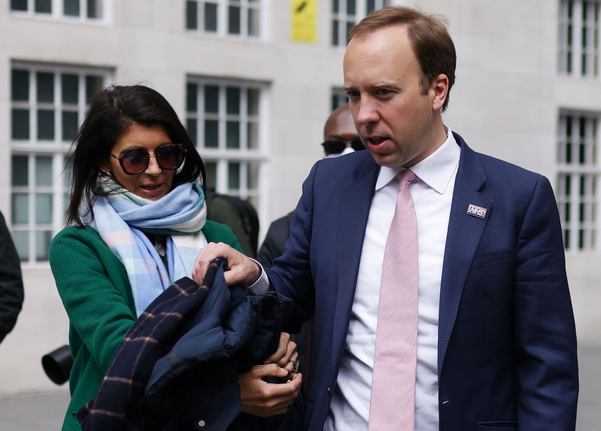 Britain's Health Secretary Matt Hancock hands his coat to his aide Gina Coladangelo (L) before a television interview outside BBC's Broadcasting House in London, Britain, May 16, 2021 - Sputnik International, 1920, 07.09.2021