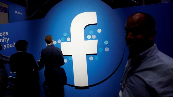 Attendees walk past a Facebook logo during Facebook Inc's F8 developers conference in San Jose - Sputnik International