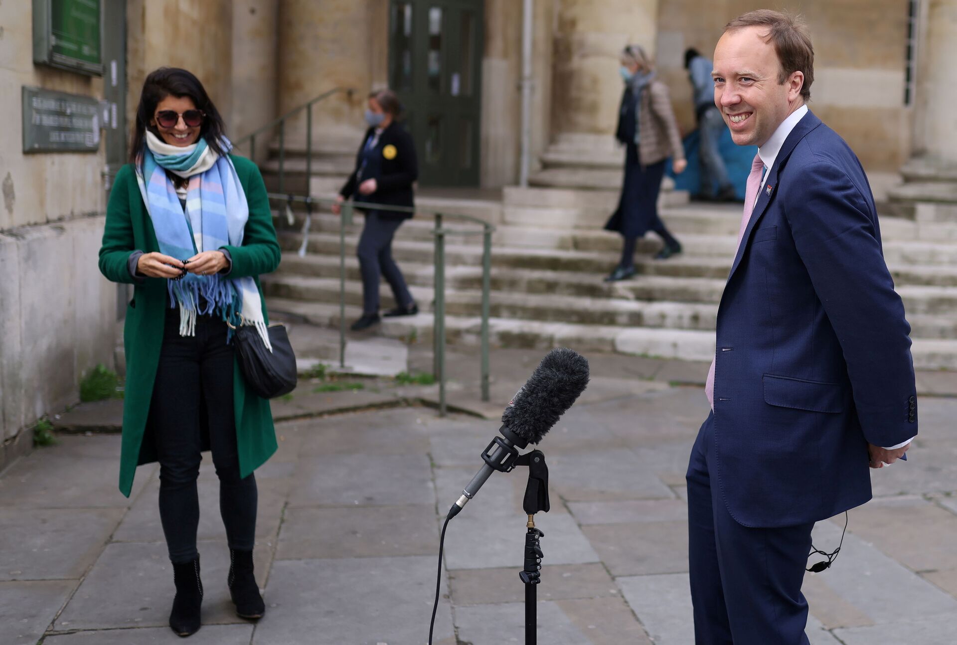 Britain's Health Secretary Matt Hancock smiles during a television interview as his aide Gina Coladangelo looks on, outside BBC's Broadcasting House in London - Sputnik International, 1920, 07.09.2021