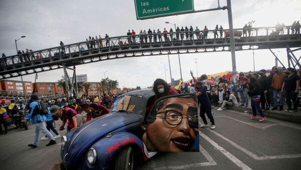  People push a car with the image of late Colombian humorist and journalist Jaime Garzon painted on it during a protest demanding government action to tackle poverty, police violence and inequalities in healthcare and education systems, in Bogota, Colombia,  June 2, 2021. - Sputnik International