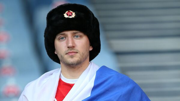 Fan with Russian flag in the stands before the match - Sputnik International