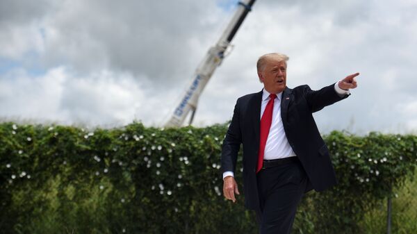 Former U.S. President Donald Trump exits the stage after visiting an unfinished section of the wall along the U.S.-Mexico border with Texas Governor Greg Abbott in Pharr, Texas, U.S. June 30, 2021.  - Sputnik International