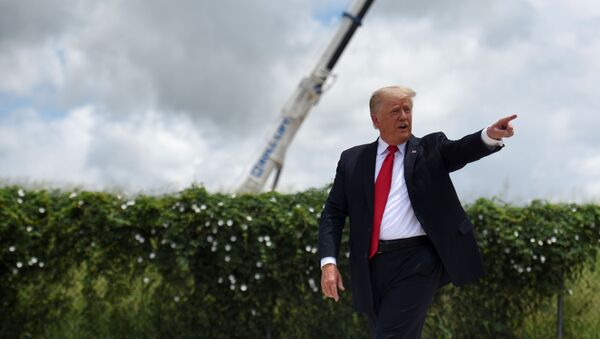 Former U.S. President Donald Trump exits the stage after visiting an unfinished section of the wall along the U.S.-Mexico border with Texas Governor Greg Abbott in Pharr, Texas, U.S. June 30, 2021.  - Sputnik International