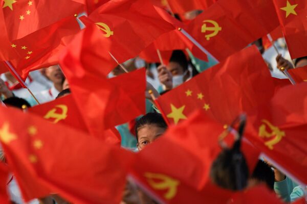 Students waiving flags during the celebration of the CCP's 100th anniversary at the Tiananmen square.  - Sputnik International
