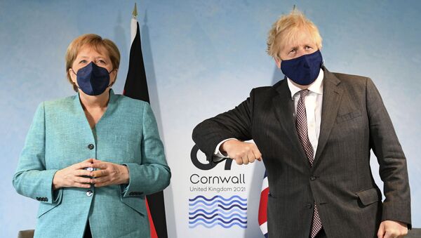Britain's Prime Minister Boris Johnson, right, greets German Chancellor Angela Merkel ahead of a bilateral meeting during the G7 summit in Cornwall, England, Saturday June 12, 2021 - Sputnik International