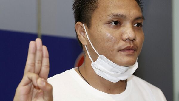 Pyae Lyan Aung, a Myanmar national football substitute goalkeeper, shows a three-finger salute after intending to seek refugee asylum at Kansai International Airport in Osaka Prefecture, Japan June 17, 2021 - Sputnik International