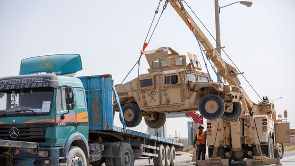 U.S. Army soldiers and contractors load High Mobility Multi-purposed Wheeled Vehicles, HUMVs, to be sent for transport as U.S. forces prepare for withdrawl, in Kandahar, Afghanistan, July 13, 2020. - Sputnik International