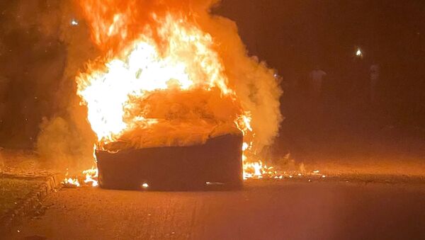 Tesla Inc's new Model S Plaid electric car is seen in flames in Pennsylvania, U.S., in this handout photo provided to Reuters on July 2, 2021. - Sputnik International