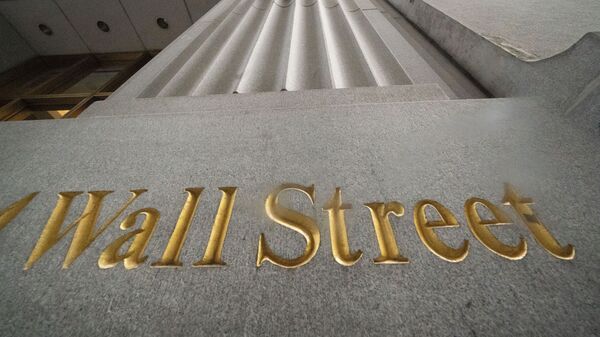 n this Nov. 5, 2020 file photo, a sign for Wall Street is carved in the side of a building. Stocks are easing lower in early trading on Wall Street, pulling major indexes slightly below the record highs they reached last week. - Sputnik International