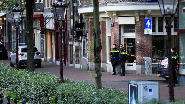 Police officers stand guard near the area where Dutch celebrity crime reporter Peter R. de Vries, known for his reporting on some of the most renowned criminals in the Netherlands, was reportedly shot and seriously injured, in Amsterdam, Netherlands, July 6, 2021. - Sputnik International