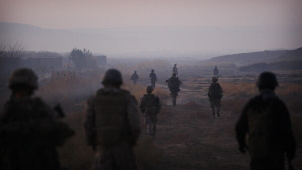United States Marines from the 2nd Battalion 2nd Marines Warlords and Afghan National Army soldiers walk in formation during an operation in the Garmsir district of the volatile Helmand province, southern Afghanistan, Wednesday, Dec. 23, 2009 - Sputnik International