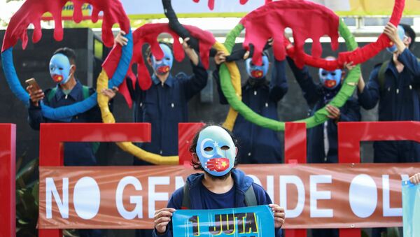 Activists wearing masks take part in a protest to boycott the Beijing 2022 Winter Olympic Games outside the Ministry of Youth and Sport of the Republic of Indonesia building in Jakarta, Indonesia, June 25, 2021 - Sputnik International