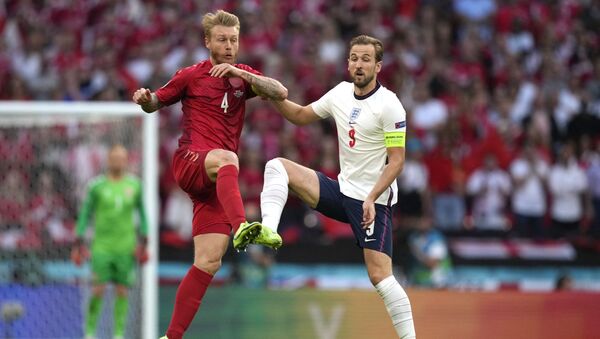 Denmark's defender Simon Kjaer (L) fights for the ball with England's forward Harry Kane during the UEFA EURO 2020 semi-final football match between England and Denmark at Wembley Stadium in London on July 7, 2021.  - Sputnik International