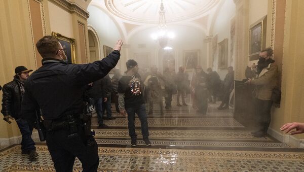 FILE - In this Jan. 6, 2021, file photo, smoke fills the walkway outside the Senate Chamber as rioters are confronted by U.S. Capitol Police officers inside the Capitol in Washington - Sputnik International
