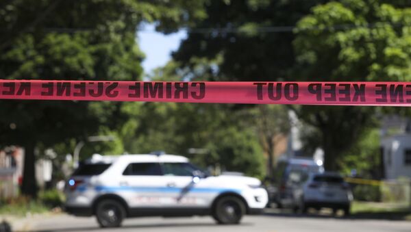 Police tape marks off a Chicago street as officers investigate the scene of a fatal shooting in the city's South Side on Tuesday, June 15, 2021. An argument in a house erupted into gunfire early Tuesday, police said. - Sputnik International