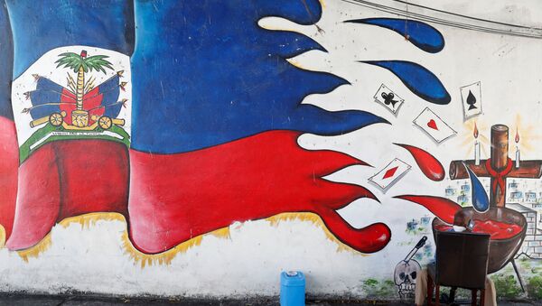A man speaks on a phone next to a mural in the Little Haiti neighborhood of Miami, Florida, U.S., July 8, 2021. - Sputnik International