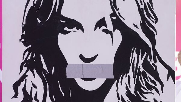 Britney Spears supporter Mark A. carries a portrait of Spears outside a court hearing concerning the pop singer's conservatorship at the Stanley Mosk Courthouse, Wednesday, March 17, 2021, in Los Angeles - Sputnik International