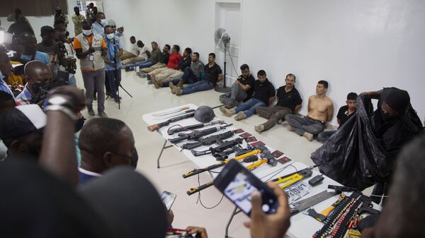 Suspects in the assassination of Haiti's President Jovenel Moise are shown to the media, along with the weapons and equipment they allegedly used in the attack, at the General Direction of the police in Port-au-Prince, Haiti, Thursday, July 8, 2021. - Sputnik International