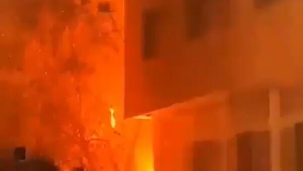 Screenshot captures a massive fire that consumed a residential building in the western district of Tehran, Iran. It is believed that the blaze was caused by a malfunction with the building's gas system; however, an investigation is ongoing. - Sputnik International