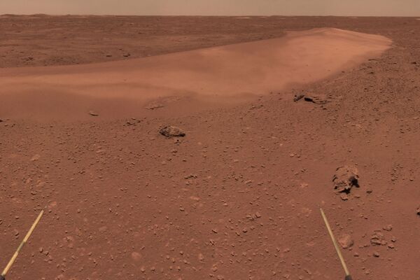 This handout photograph taken on June 26, 2021 and released on July 9, 2021 by the China National Space Administration (CNSA) shows the surface of Mars taken from China's Zhurong Mars rover. (Photo by HANDOUT / China National Space Administration (CNSA) / AFP) / -----EDITORS NOTE --- RESTRICTED TO EDITORIAL USE - MANDATORY CREDIT AFP PHOTO / CNSA - NO MARKETING - NO ADVERTISING CAMPAIGNS - DISTRIBUTED AS A SERVICE TO CLIENTS - Sputnik International