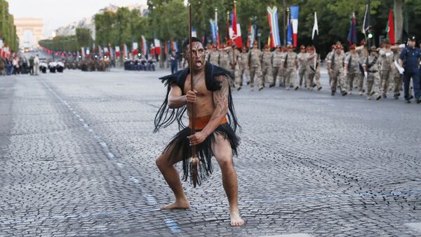 A Maori soldier gestures as New Zealand's soldiers march down the Champs Elysees in Paris during a rehearsal of the annual Bastille Day military parade on 12 July 2016.  - Sputnik International