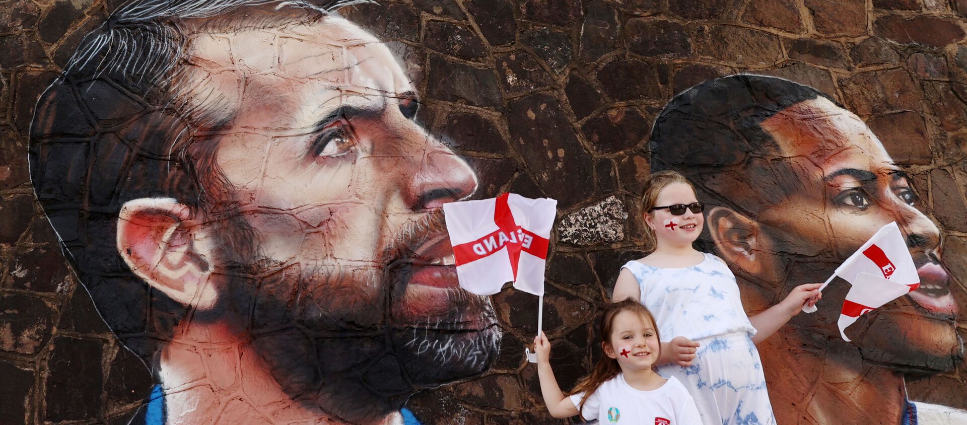 Soccer Football - England fans pose for a photograph in front of a giant mural created by street artist Nathan Parker of Gareth Southgate, Harry Kane and Raheem Sterling ahead of the Euro 2020 final against Italy - Bullring, Nuneaton, Britain - July 10, 2021 - Sputnik International, 1920, 12.07.2021