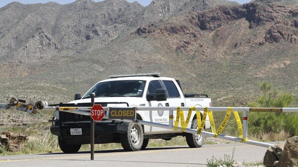 A Texas State Park police officer sits in a patrol truck guarding an entrance to the Franklin Mountains Sunday, April 19, 2020, in El Paso, Texas.  - Sputnik International