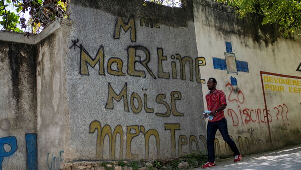 A man walks past a graffiti that reads Martine Moise near the house where President Jovenel Moise was assassinated, in Port-au-Prince, Haiti July 11, 2021. - Sputnik International