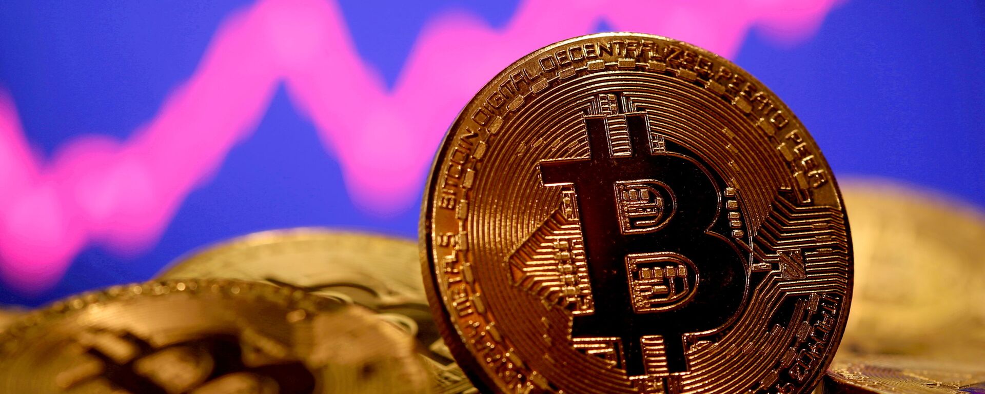 A representation of virtual currency Bitcoin is seen in front of a stock graph in this illustration taken January 8, 2021 - Sputnik International, 1920, 18.05.2022
