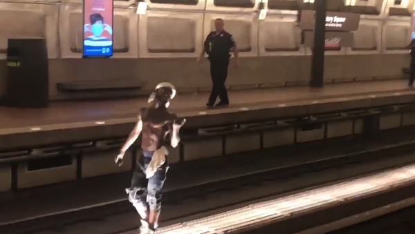Screenshot from a video allegedly filmed inside the Washington DC Metro, where an unidentified man is seen walking on the tracks - Sputnik International