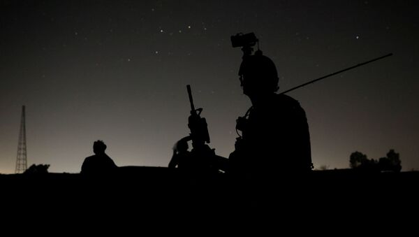 Members of the Afghan Special Forces keep a watch as others search houses in a village during a combat mission against Taliban, in Kandahar province, Afghanistan, July 12, 2021 - Sputnik International