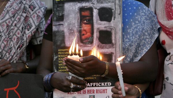 Women hold candles during a protest organized by a non government organization against alleged human trafficking and urged people to be vigilant, in Bangalore, India, Tuesday, March 18, 2008 - Sputnik International