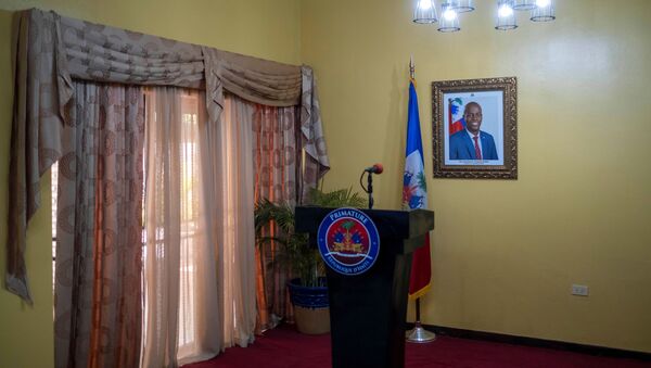 A picture of the late Haitian President Jovenel Moise hangs on a wall before a news conference by interim Prime Minister Claude Joseph at his house, almost a week after his assassination, in Port-au-Prince, Haiti July 13, 2021 - Sputnik International